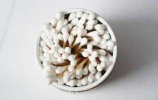 Container filled with cotton swabs